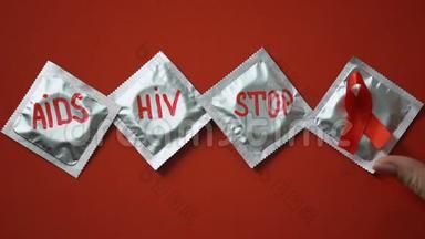 <strong>预防艾滋病</strong>：在红色背景下用红丝带在避孕套上